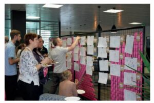 People pinning envelopes to a wall
