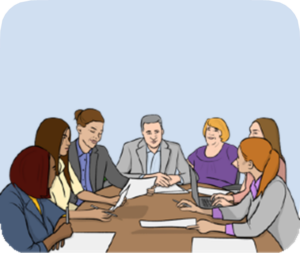 A big group of people sat around a conference tbale discussing documents